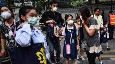 Parents bring their children to school wearing protective face masks in Bangkok, Thailand, on February 3, 2020. AFP
