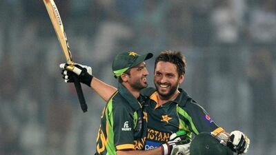 Pakistan cricketers Shahid Afridi and Junaid Khan celebrate after their last-over heroics against India on Sunday, March 2, 2014. Munir uz Zaman / AFP