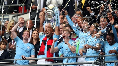 Vincent Kompany of Manchester City lifts the trophy following the FA Cup Final match between Manchester City and Watford at Wembley Stadium. Getty Images