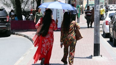 People take shelter from the sun in Bur Dubai. Chris Whiteoak / The National
