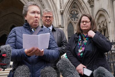 Cathy Gardner (left) and Fay Harris (right), whose fathers died from Covid-19, speaking outside the Royal Courts of Justice in central London. PA