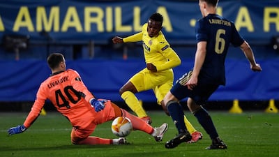 Zagreb goalkeeper Dominik Livakovic saves from Villarreal's Samuel Chukwueze. Reuters
