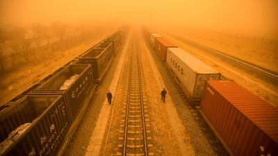 Police officers check train cars at a border checkpoint during a sandstorm in Erenhot, a city in China's northern Inner Mongolia region. AFP