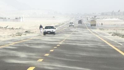 Sand sweeps across the highway in the Umm Nahad 3 area of Dubai. Pawan Singh/The National