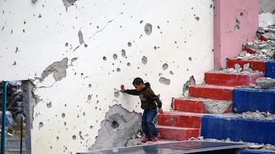 A child walks down the steps of a damaged sports stadium in the Bureij refugee camp, central Gaza. AFP