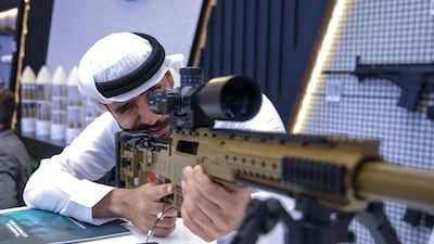 A visitor at a past exhibition takes a look at a 7.62x51 calibre rifle. Victor Besa / The National