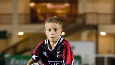 A youngster runs with the ball during the All Blacks' training session with Exile juniors. Duncan Chard for The National