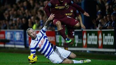 QPR's Shaun Derry battles to keep Sergio Aguero away from the ball at Loftus Road.