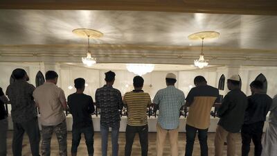 Worshippers join together to pray after iftar.