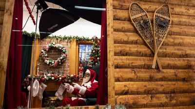 Santa Larry speaks with a virtual visitor at the Santa Experience in the Mall of America in Bloomington, Minnesota. The owners had initially set up a socially distanced set, featuring a cabin with a plexiglass window, but moved completely online after new Covid-19 restrictions were put in place. Getty Images