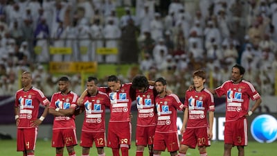 The Al Jazira players watch on from the half way line during the Super Cup penalty shootout. Mike Young / The National