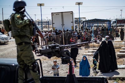 A member of the Kurdish security forces stands guard as Syrian detainees are released from Al Hol camp in September 2023. AFP
