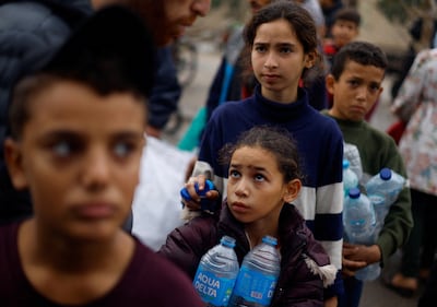 People queue for water in Rafah after Israel cut off water and electricity to Gaza. Reuters
