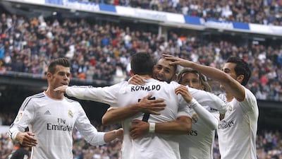 Cristiano Ronaldo celebrates with Real Madrid teammates including Karim Benzema, centre, and Gareth Bale, left. Elisa Estrada / Getty Images