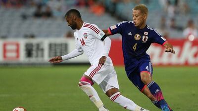 Keisuke Honda of Japan, right, fights for the ball with Abdulaziz Sanqour of the UAE during their Asian Cup quarter-final match on Friday. Craig Golding / AFP