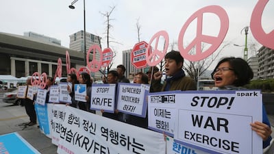 Protesters stage a rally to denounce the annual joint military exercises between South Korea and the United States near the US Embassy in Seoul. Ahn Young-joon / AP