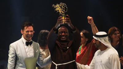 Sheikh Hamdan bin Mohammed, Crown Prince of Dubai, and Hugh Jackman, left, congratulate Peter Tabichi for winning the Global Teacher Prize in Dubai AP