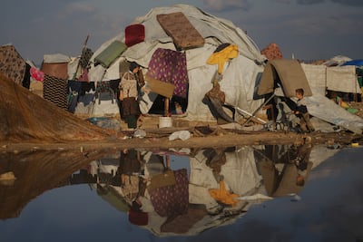 Clothes and mattresses hang on a tent in a flooded camp in Gaza city. AP