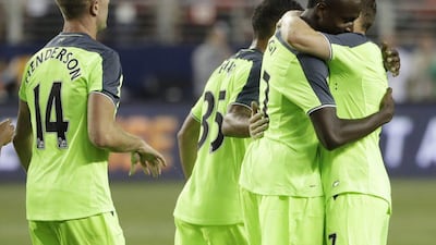 Liverpool’s Divock Origi, centre, is hugged by teammate James Milner, right, after Origi’s goal against AC Milan during the second half of an International Champions Cup match Saturday, July 30, 2016, in Santa Clara, California. Marcio Jose Sanchez / AP Photo