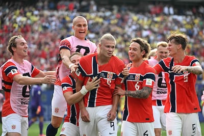 Teammates mob Erling Haaland, centre, after the first of his two goals against Brazil. AFP