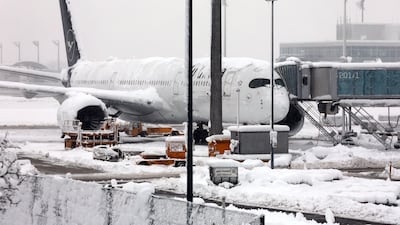 A Lufthansa aircraft is parked at the snow-covered Munich airport after all flights were cancelled on Saturday following a winter storm. AP
