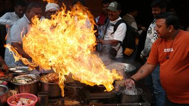 The heat is on at this roadside stall as a street vendor prepares food in Varanasi, India. AFP