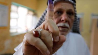 A voter in the Sadr City district of Baghdad proudly holds up an ink-stained finger, the mark of casting his vote in the first Iraqi elections since the defeat of ISIS, on May 12, 2018. Wissm Al Okili / Reuters