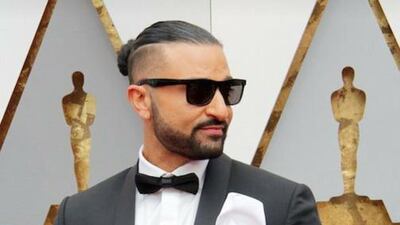 Kris Fade wears a bespoke suit by The Custom Shop while reporting from the Oscars red carpet. Courtesy of The Custom Shop