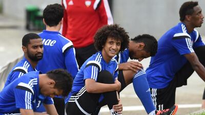 UAE's Omar Abdulrahman, smiling centre, shown stretching before the team's training session on Thursday in anticipation of their Asian Cup quarter-final match on Friday. Photo Courtesy / UAE FA