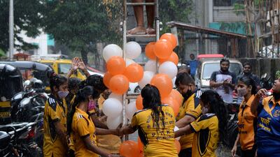 A group of girls take part in a Dahi Handi using a ladder in Mumbai. AFP