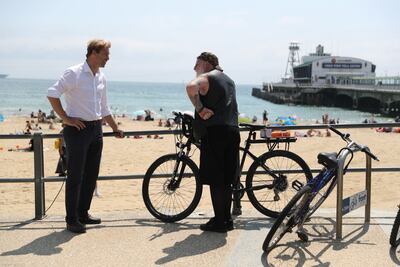 Tobias Ellwood speaks to a member of the public near Bournemouth Pier. Getty Images