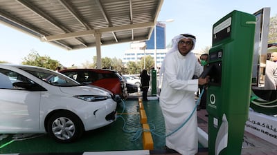 Majid Al Hazami from Dewa charges a car at the electricity authority's headquarters in Garhoud, Dubai in February 2015. The government will allow electric car owners to charge for free until the end of 2021. Pawan Singh / The National