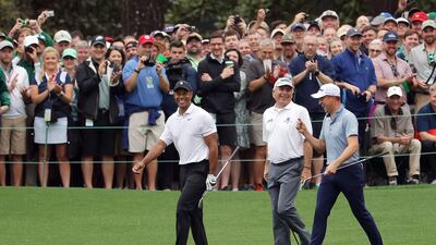 Left to right: Tiger Woods, Fred Couples and Justin Thomas on the 16th hole. Getty