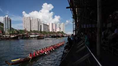 Competitors paddle their boat after racing during the annual Dragon Boat Festival in Hong Kong on Saturday. Dale de la Rey / AFP