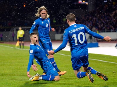 Johann Berg Gudmundsson, left, celebrates scoring Iceland's second goal in the 2-0 win over Kosovo. Haraldur Gudjonsson / AFP