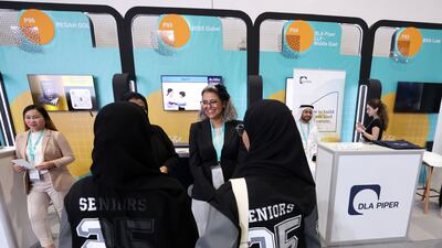 Final year pupils visit a recruitment stand for a Dubai school at the Ru'ya careers fair. Chris Whiteoak / The National