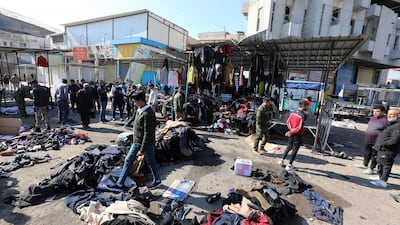 epa08955229 Iraqis clean the site of the second bomb explosion in a central Baghdad used clothes market, Iraq, 21 January 2021. According to local media reports, two bombs exploded in a popular commercial area in central Baghdad on 21 January morning. At least 31 people were killed and dozens were injured. EPA/AHMED JALIL