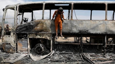 A man jumps out of a burnt bus after an overnight fire. Reuters