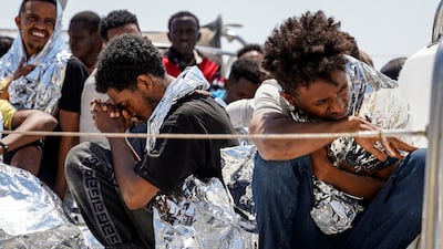 Migrants sit on the deck of a coast guard vessel upon their arrival at Mytilene port, on the northeastern Aegean Sea island of Lesbos, Greece, on June 22. AP Photo