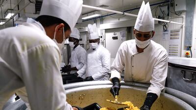 The biryani is put into small boxes.