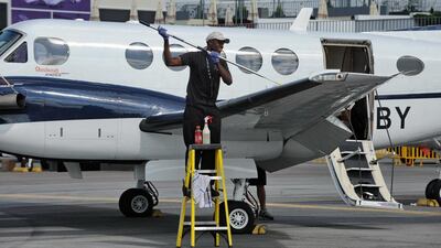 American workers parking private jets at Palm Beach International Airport in Florida earn $13 an hour, or just one dollar higher than those who clean toilets of these aircraft. Roslan Rahman / AFP