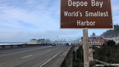 A sign marks the entry to Depoe Bay, Oregon during an extreme high tide that coincided with a big winter storm. AP Photo