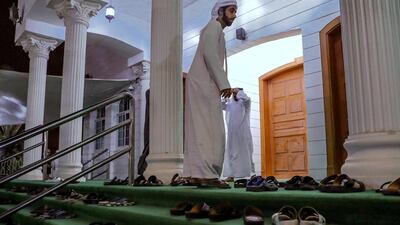 Worshippers go to a mosque close to the Sheikh Zayed Grand Mosque for Fajr on the first day of Ramadan. Victor Besa / The National
