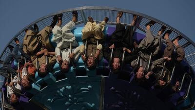 Visitors ride a fairground ride at the Park Shahar or City Park in Kabul. September 6, 2017. Shah Marai / AFP