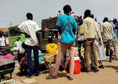 People wait to hitch a ride out of Khartoum as the Sudanese army and the paramilitary Rapid Support Forces clash in the capital. Reuters