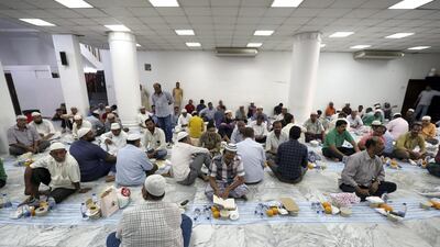 Worshippers enjoy iftar at Lootah Mosque.