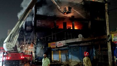 Fire officials try to douse the blaze. AP