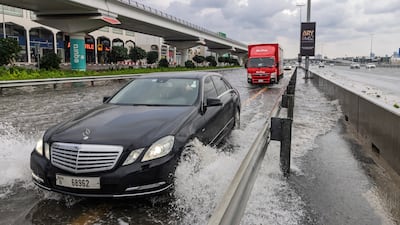 Drivers plough through waterlogged roads in Al Quoz, Dubai, during last week's rainstorms. Antonie Robertson / The National
