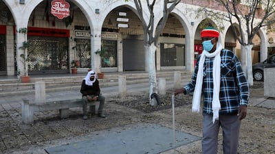 A man walks in front of shutetred shops in Bethlehem in the occupied West Bank amid the coronavirus pandemic. AFP