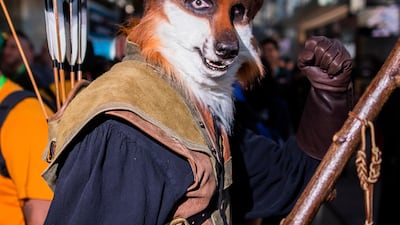 An attendee dressed as Disney's 'Robin Hood' poses during New York Comic Con. AP